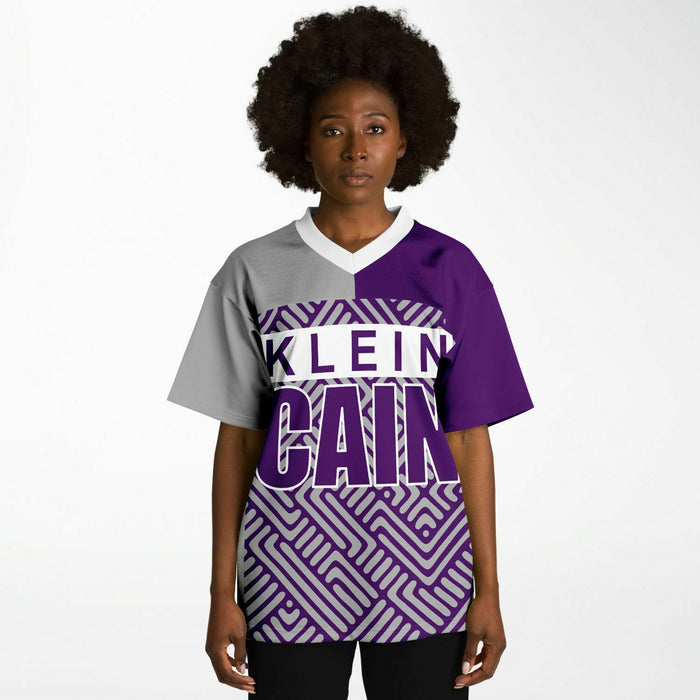 Black woman wearing Klein Cain Hurricanes football Jersey